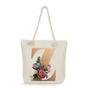 Detailed view of the stylish canvas tote bag featuring a metallic gold letter Z and floral print.