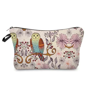 Close-up view of the cosmetic pouch showing detailed owl and floral print texture.