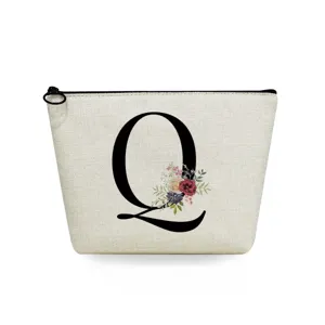 Close-up detail of white canvas cosmetic pouch with elegant black letter Q and floral art.