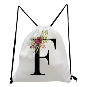 White canvas drawstring backpack featuring a stylish floral letter F print design for daily use.