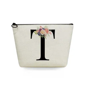 Linen cosmetic bag featuring a floral letter T print with secure black zipper closure.