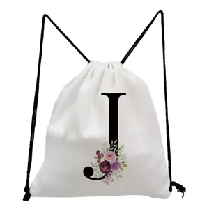 Minimalist white canvas drawstring backpack featuring a black letter J and floral print detail.