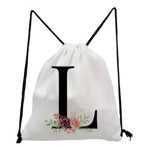 White drawstring backpack featuring a black letter L and watercolor floral print detail.