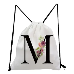 White drawstring backpack with floral letter M print, casual minimalist gym bag.