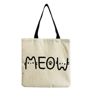 Detailed view of canvas tote bag with cute cat letter print and black handles for daily casual use.