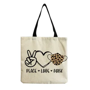 Detailed view of the canvas shoulder tote bag featuring stylish graphic print and black handles.