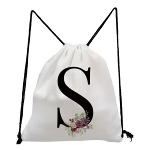 Minimalist white drawstring backpack with custom letter S and floral print for everyday use.