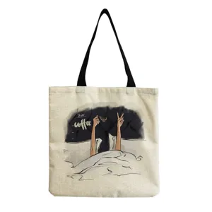 Detail view of the canvas tote bag featuring a unique coffee illustration and black straps.