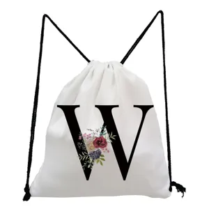 White drawstring backpack detail featuring a stylish black letter W and floral print design.