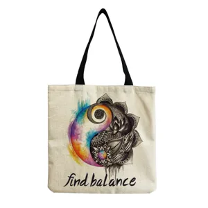 Canvas tote bag detail showing artistic watercolor yin-yang mandala print and inspirational text.