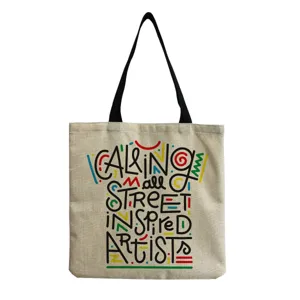 Detailed view of the stylish canvas tote bag with artistic typography and durable handles.