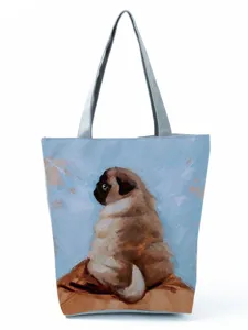 Detailed view of the cute pug print design on the stylish canvas tote bag fabric surface.