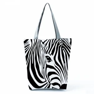 Close-up of the artistic zebra pattern print and fabric texture on the casual canvas tote bag.