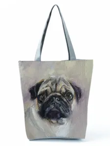 Canvas tote bag featuring a detailed artistic pug dog oil painting print close-up view.