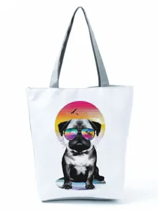 Close-up view of the cute pug graphic printed on the white canvas tote bag with grey straps.