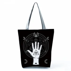 Black canvas tote bag detail showcasing occult all-seeing eye and geometric print pattern.