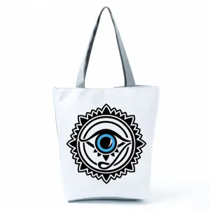 Close-up view of a casual canvas tote bag with a striking black and blue mystic eye print design.