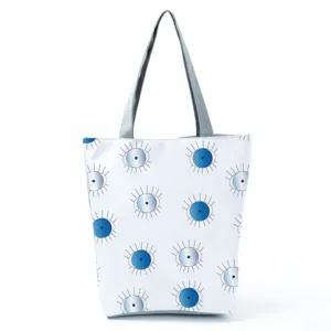 Large capacity white tote bag with blue abstract eye pattern and grey handle casual style.