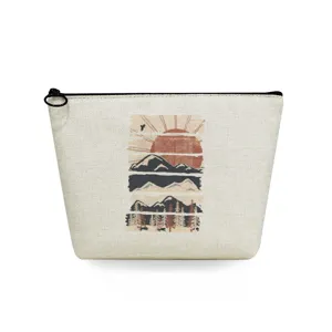 Close-up detail of the portable canvas cosmetic pouch featuring a boho landscape graphic print.