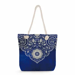 Blue and white porcelain style canvas tote bag detail, featuring intricate floral pattern and rope handles.