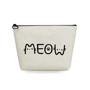 Close-up detail of beige canvas cosmetic pouch featuring cute cat lettering print and black zipper.
