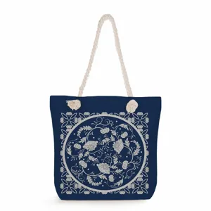Detailed view of blue canvas tote bag with vintage floral pattern and thick rope handles.
