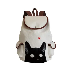 Canvas backpack detail featuring cute black cat print and red heart design close-up view.
