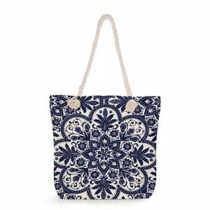 Blue and white porcelain pattern canvas tote bag detail, featuring durable rope handles and print.