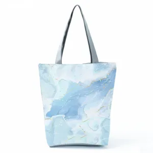 Blue marble pattern tote bag detail view showing watercolor abstract design with gold accents.