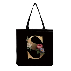 Black canvas tote bag with gold letter S and vintage floral print, casual shoulder bag for women.