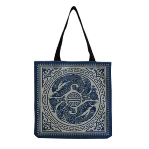 Detailed view of vintage blue canvas tote bag showcasing traditional phoenix pattern print design.