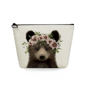 Close-up of canvas cosmetic bag with cute baby bear and floral crown print, secure zipper.