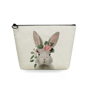Close-up detail of the cute bunny and floral wreath print on the portable canvas makeup pouch.