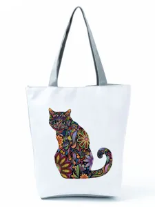 Sac a main en toile avec imprime chat floral colore, ideal pour les voyages quotidiens.