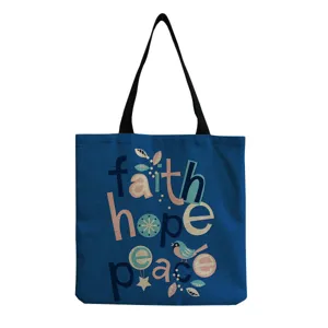 Blue canvas tote bag detail, featuring colorful faith hope peace typography and cute bird print.