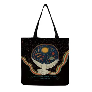 Close-up detail of black canvas tote bag featuring retro celestial dove and star graphic