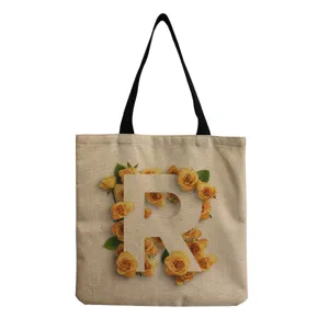 Detailed view of a stylish cotton linen tote bag featuring letter R and yellow roses print.
