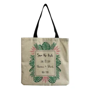 Detail view of the cotton linen tote bag featuring tropical leaf print and custom wedding text.