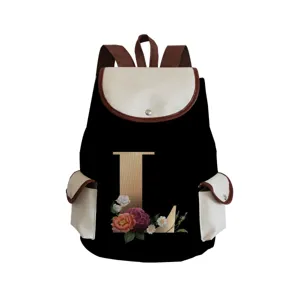 Close-up detail of the black canvas backpack featuring a floral letter L print and front pockets.