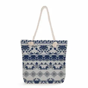 Blue and white porcelain pattern canvas tote bag detail, featuring durable thick rope handles.