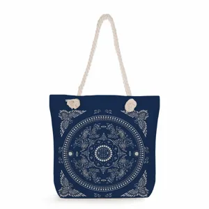 Blue canvas tote bag detailed view featuring intricate white mandala pattern and rope handles.