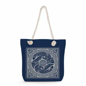 Detailed view of the blue canvas tote bag with traditional print and thick rope handles.
