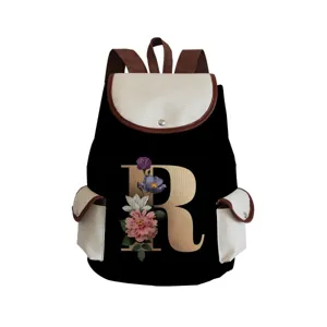 Detailed view of black canvas backpack featuring elegant floral letter R print and brown straps.