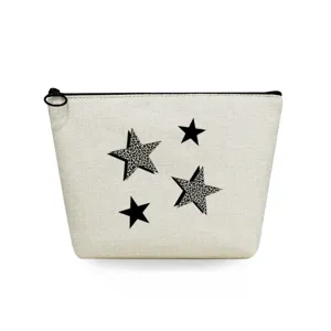 Close-up detail of canvas cosmetic bag featuring chic leopard print stars and black zipper.
