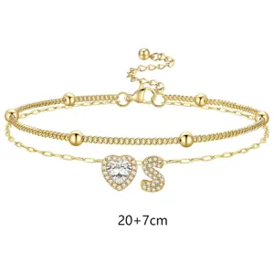 Bracelet de cheville double doré avec cœur en zircone et pendentif lettre S réglable.