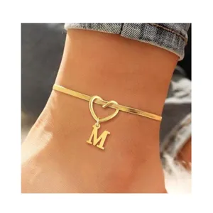 Stainless steel initial snake chain anklet with heart motif and letter M pendant.