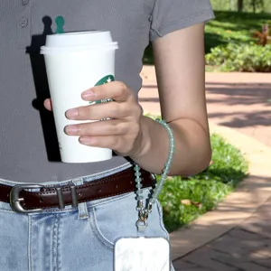 Detailed view of natural stone beaded phone wrist strap, elegant and stylish accessory.