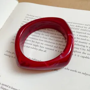 Red acrylic faceted bracelet detail shot, elegant geometric resin bangle close up view