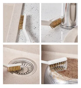 Detailed view of wire brush cleaning kitchen sink, faucet, and pot bottom