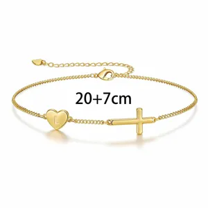 Gold tone cross heart charm bracelet with letter L and adjustable 20+7cm extension chain.